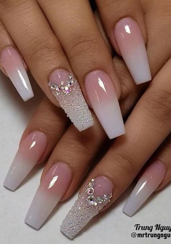 Chic Ombre Nails: Soft Pink to White Gradient with Sparkling Rhinestone Accents.