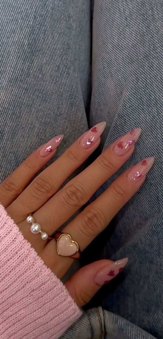 Elegant Almond-Shaped Nail Design with Heart Accents and Coordinated Jewelry