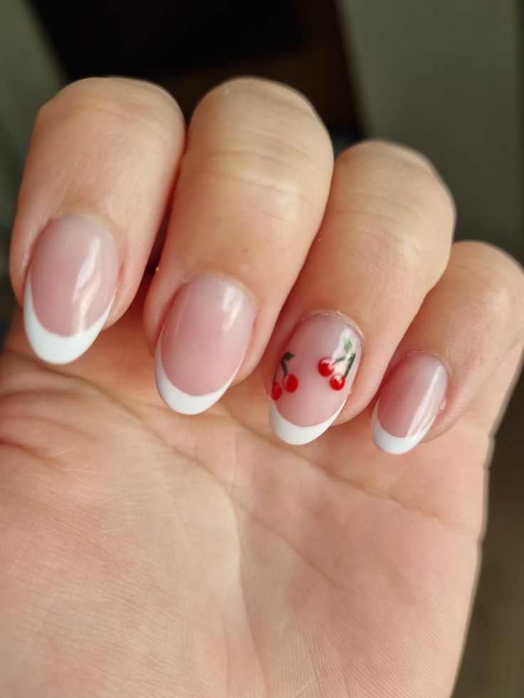 Elegant French Tip Nails with Playful Cherry Blossom Accents.