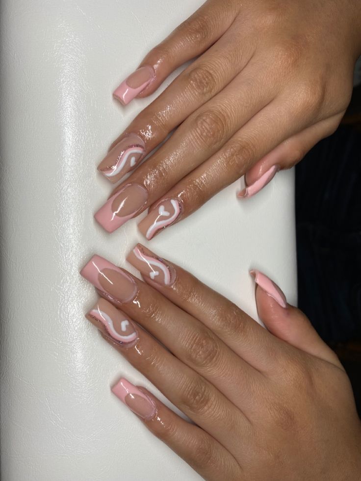 Chic Nail Design: Elegant Soft Pink with Clear Finishes and Intricate White Swirls.