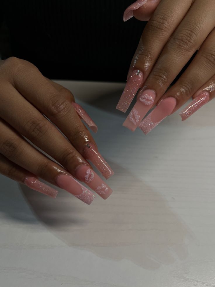 Chic Long Pink Nails with Shimmering Accents and Artistic Patterns