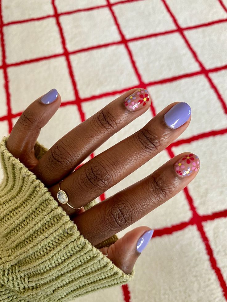 Whimsical Lavender Nail Design with Floral Accents and Playful Pastel Tones.