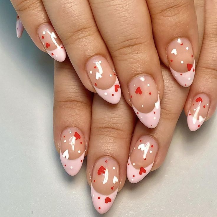 Charming Soft Pink Nail Design with Heart Accents and Whimsical Dots.