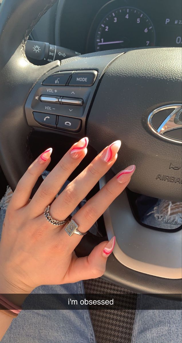 Elegant Pink and White Swirled Nail Design: A Trendy Statement for Bold Manicures.