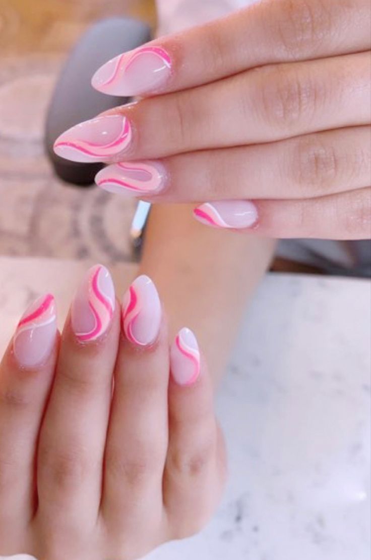 Chic Nail Design with Soft Base Coat and Delicate Pink Swirls.