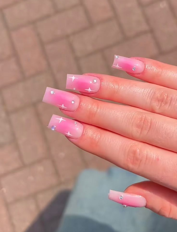 Chic Gradient Pink Nail Design with Star Accents and Rhinestones for a Glamorous Look