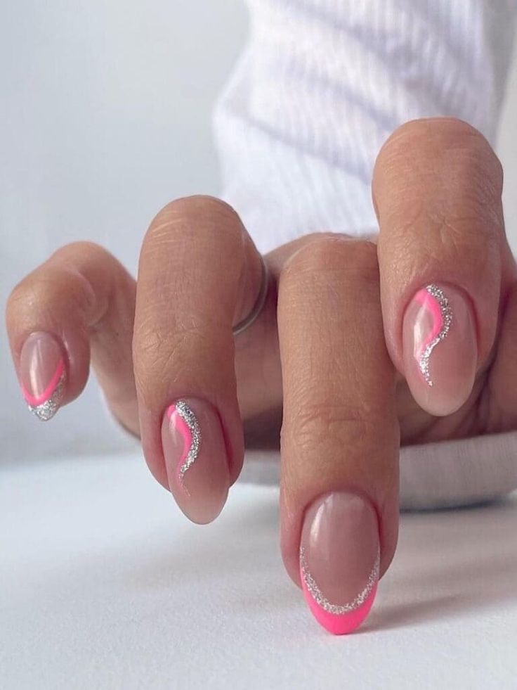 Playful Nude Nail Design with Vibrant Pink Waves and Sparkling Accents.