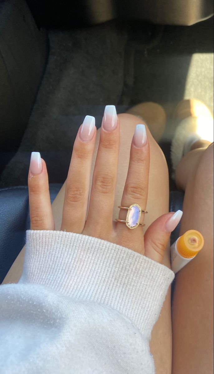 Elegant Pastel Ombre Nails with French Tips and Iridescent Ring Accent.