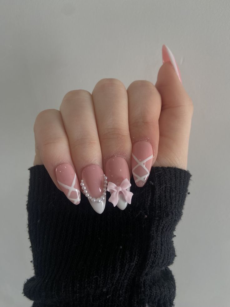 Chic and Feminine Nail Design with Soft Pink and White Hues, Featuring Delicate Patterns and Pearl Accents.