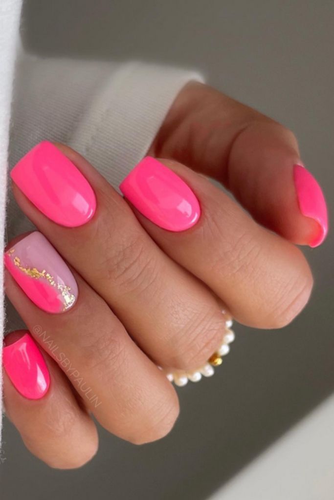 Elegant Glossy Vibrant Pink Nail Design with Gold Accents for Lively Occasions.