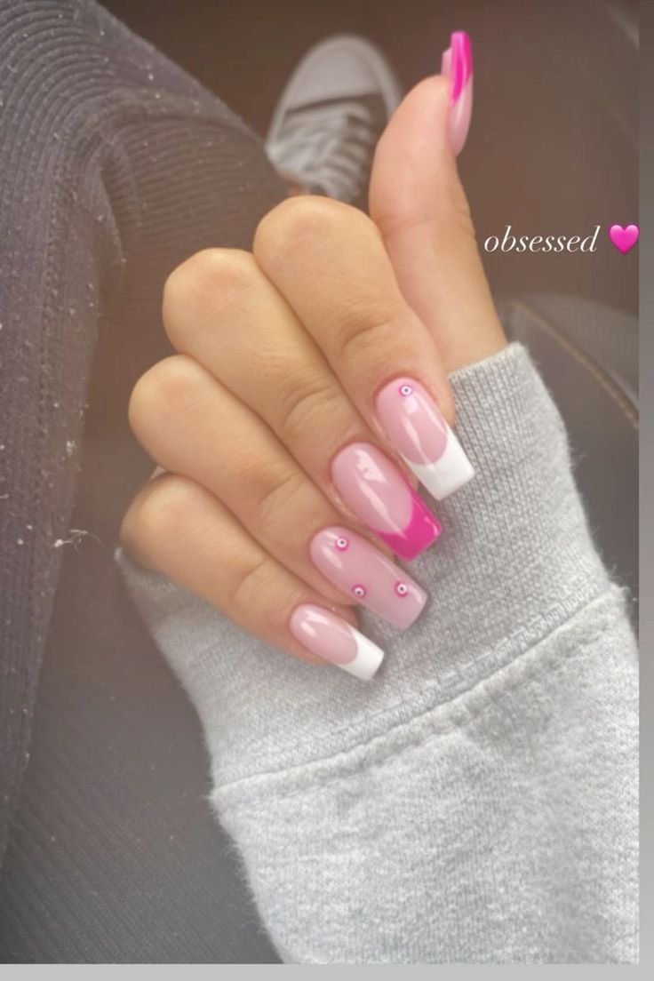 Chic Playful Manicure: Elegant Soft Pink and White Nail Design with French Tips and Gem Accents.