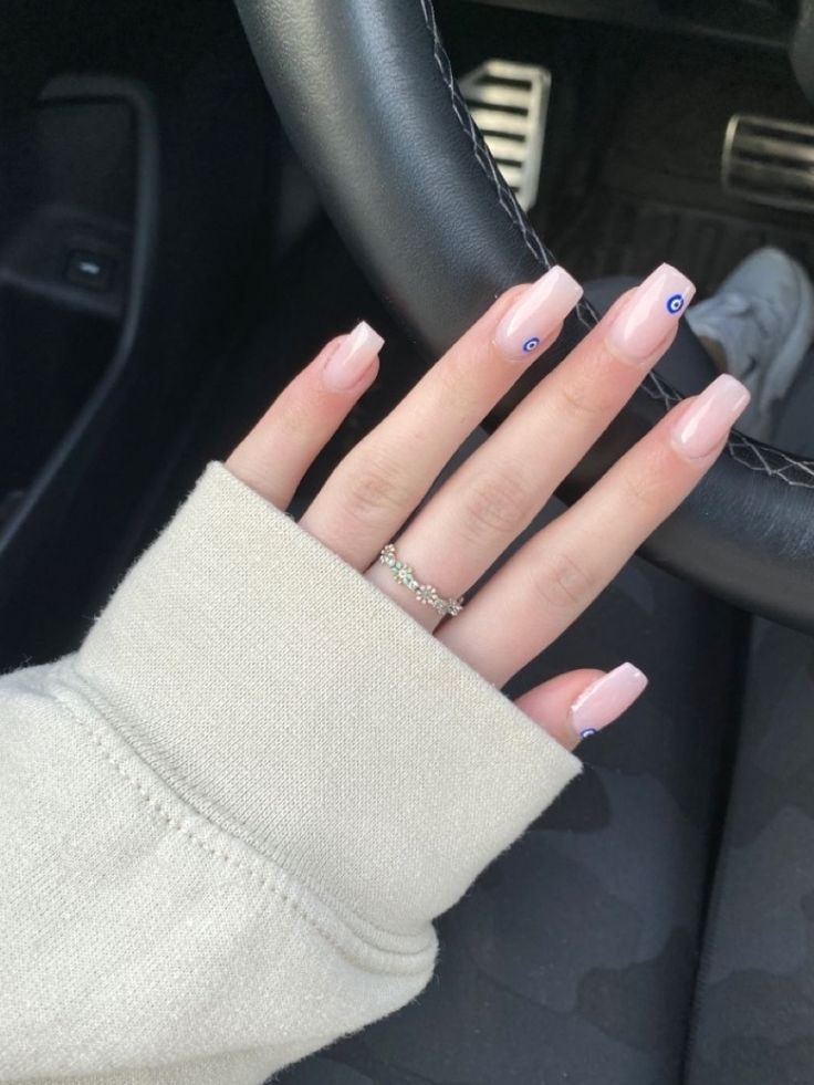 Elegant Long Nails with Soft Pink Polish and Trendy Blue Eye Accent