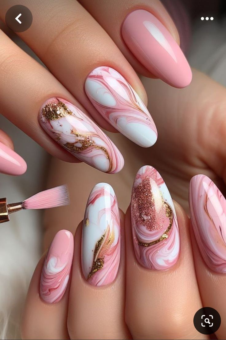 Chic Marble Nail Design: Soft Pink and White with Glamorous Gold Accents.