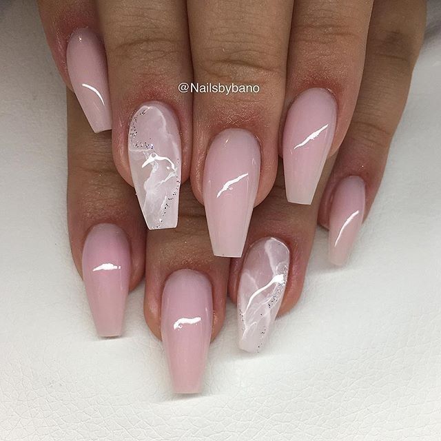 Chic Stiletto Nail Design with Soft Blush Base and Sophisticated Marble Accents.