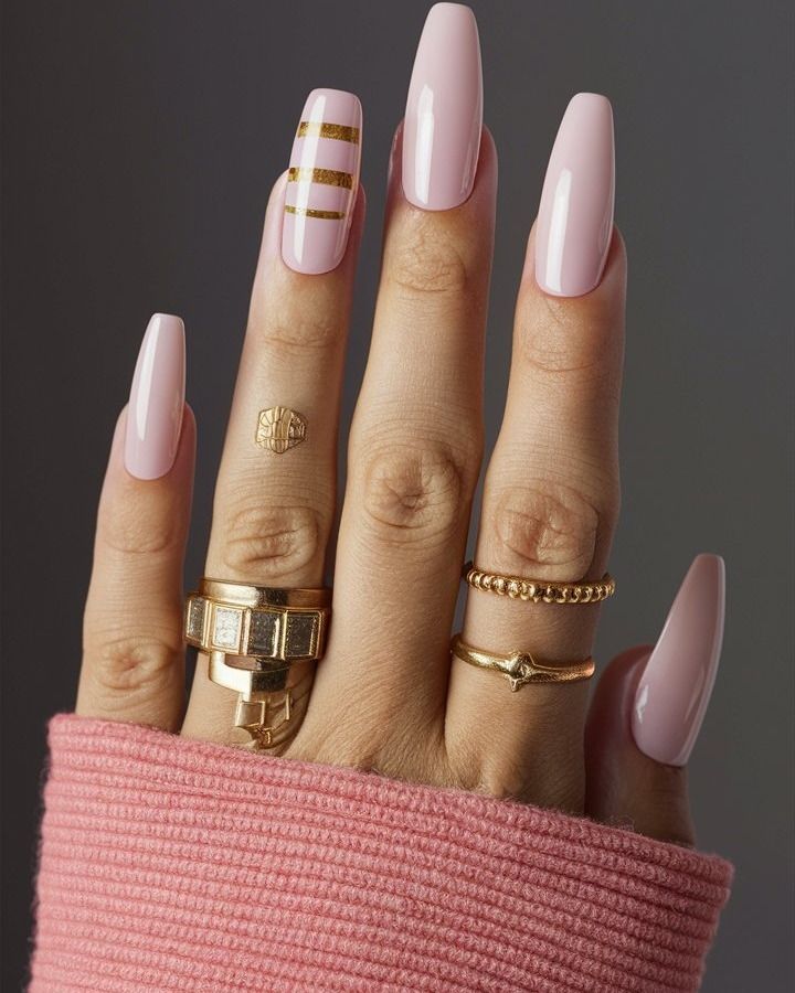 Chic Pink Glossy Nails with Glam Gold Accents and Stylish Rings