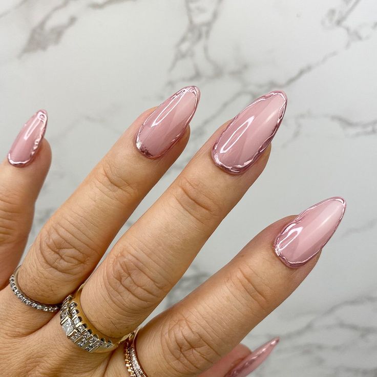 Sophisticated Almond-Shaped Nails: Glossy Pink with Subtle Metallic Outline for Versatile Glamour.