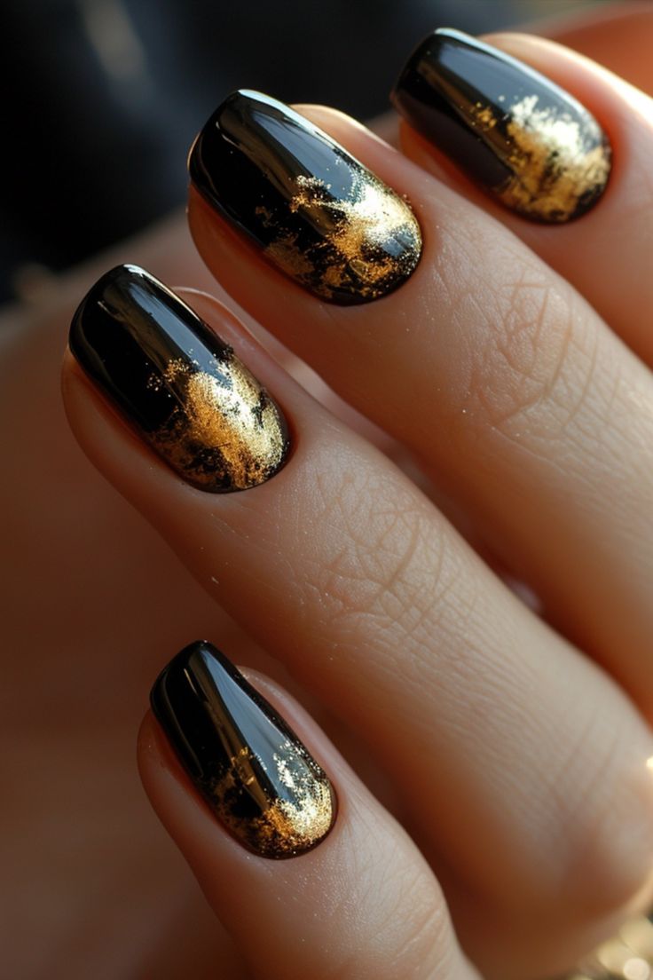 Sophisticated Black and Gold Glossy Nail Design with Intricate Accents