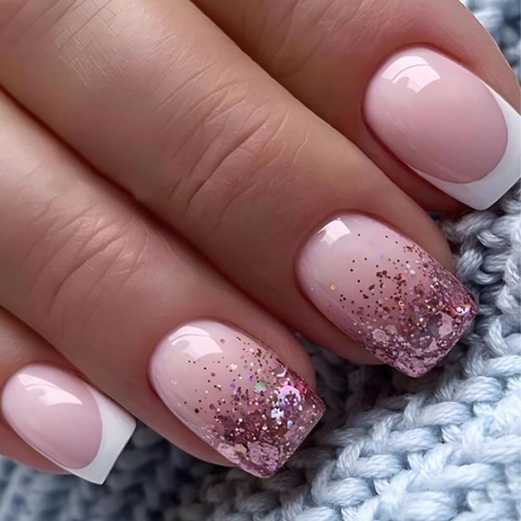 Elegant Pink Ombre Nails with Glittery French Tips for a Chic Look.