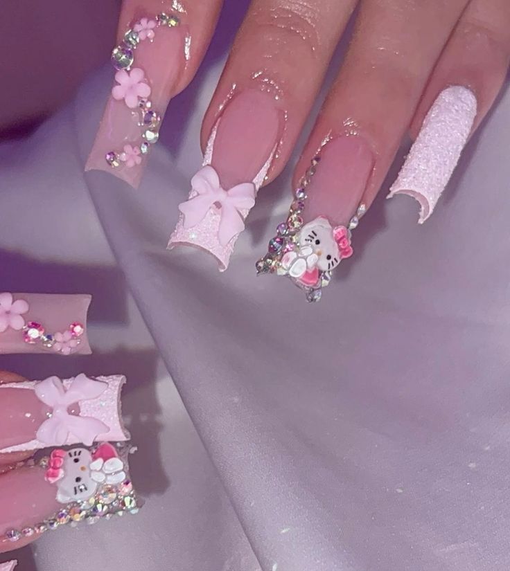 Charming Whimsical Nail Art: Soft Pink Palette with Hello Kitty, Flowers, and Sparkling Embellishments.