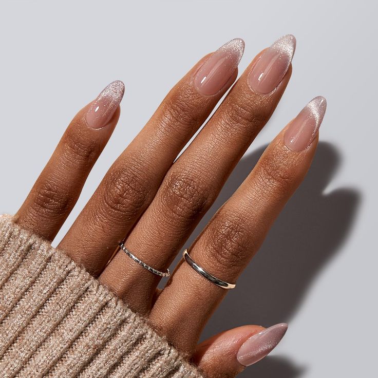 Sophisticated Almond-Shaped Nails with Delicate Shimmering French Tips and Simple Silver Accents.