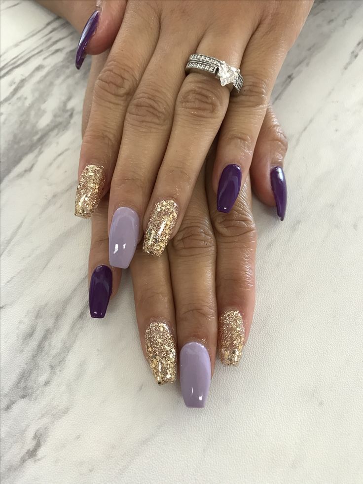 Elegant Almond-Shaped Nail Design with Rich Purple and Shimmering Gold Accents.