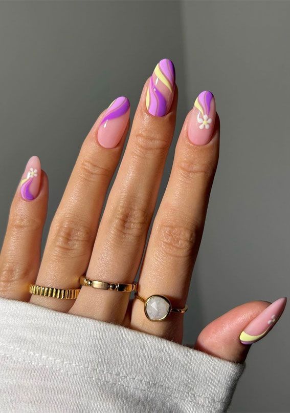 Whimsical Pastel Nail Design with Floral Accents and Complementary Rings.