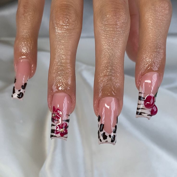 Trendy Bold Nail Design: Playful Patterns with Pink Base, Leopard Accents, and Floral Elegance.