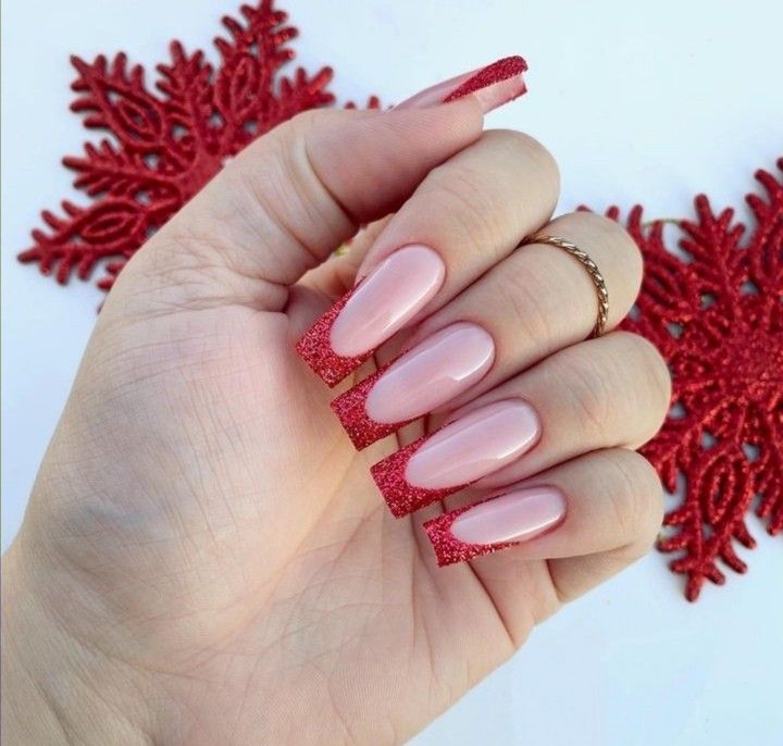 Elegant Nude Nail Design with Striking Red Glitter Accents for Festive Occasions.