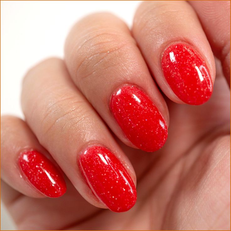 Dazzling Bold Red Glitter Nails: Glamorous Oval Manicure for Statement Occasions.