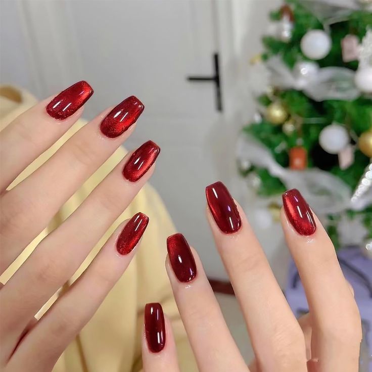 Elegant Ruby Red Gradient Nail Design with Glossy and Glittery Finishes for Festive Chic.