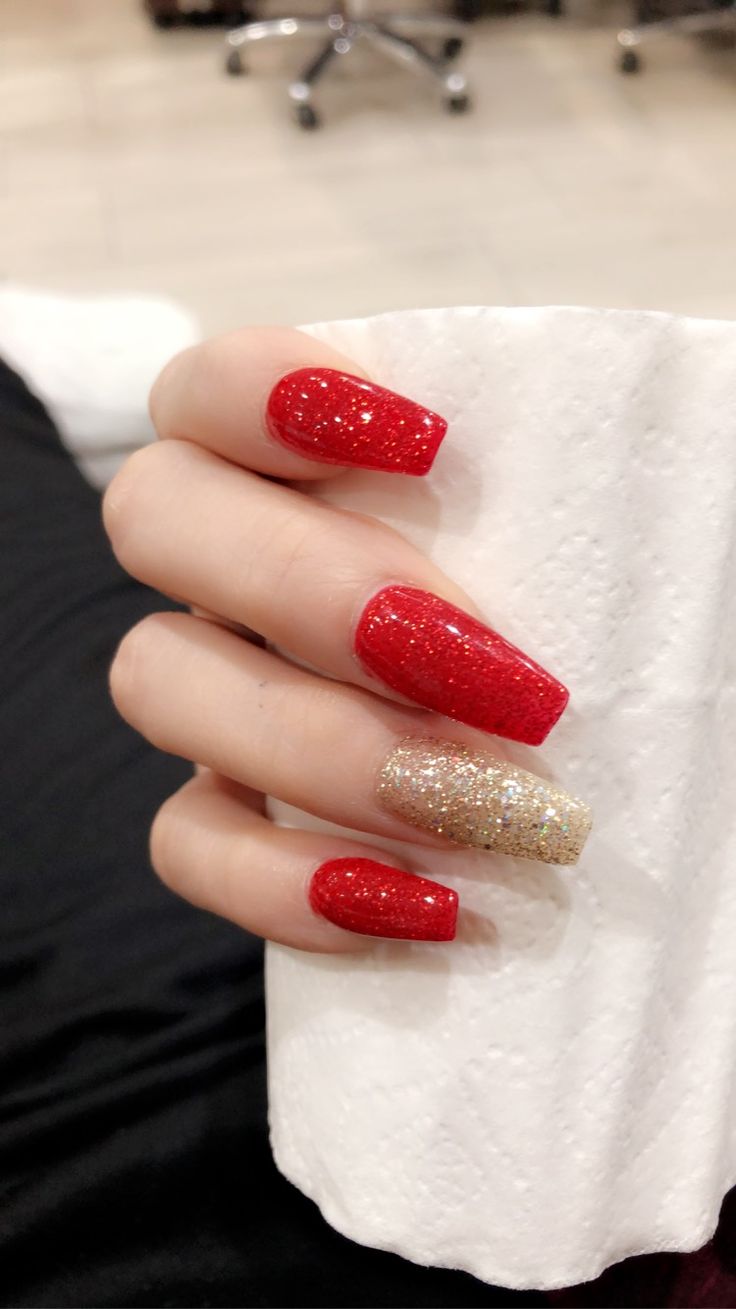 Festive Vibrant Red and Gold Glitter Nail Design for Special Occasions.