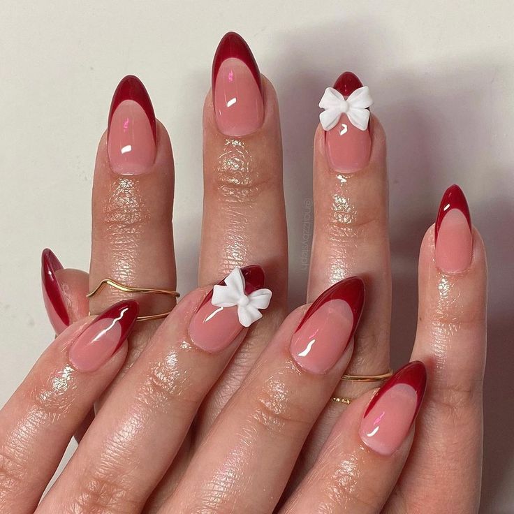 Chic French Tip Nail Design: Soft Pink, Bold Red, and Playful White Bows.