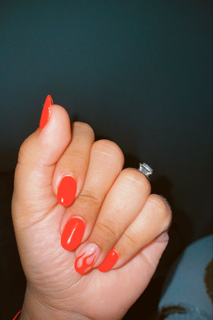 Modern Flame-Accented Red Manicure: A Bold Blend of Fun and Sophistication.