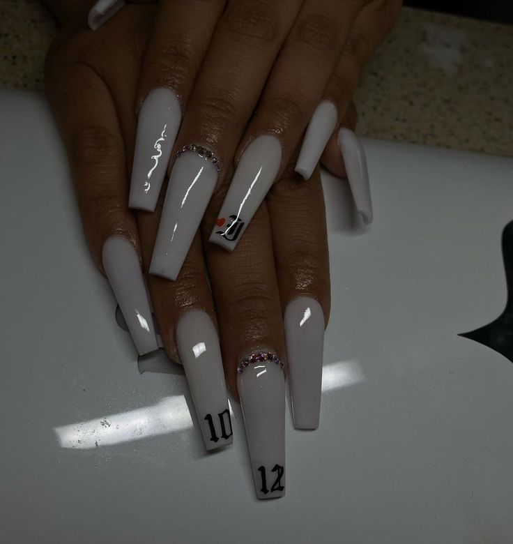 Sophisticated Long Gray Acrylic Nails with Sparkling Accents and Unique Number Designs.