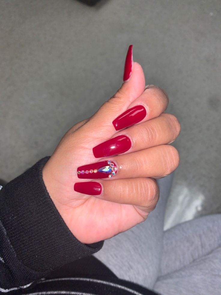 Chic Elegant Red Nail Design with Rhinestone Accents for Glamorous Occasions.