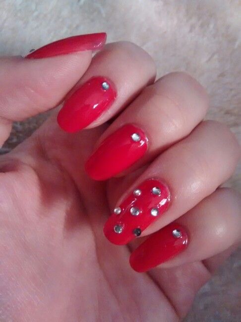 Glamorous Red Nails with Shimmering Rhinestones: A Perfect Blend of Boldness and Elegance.