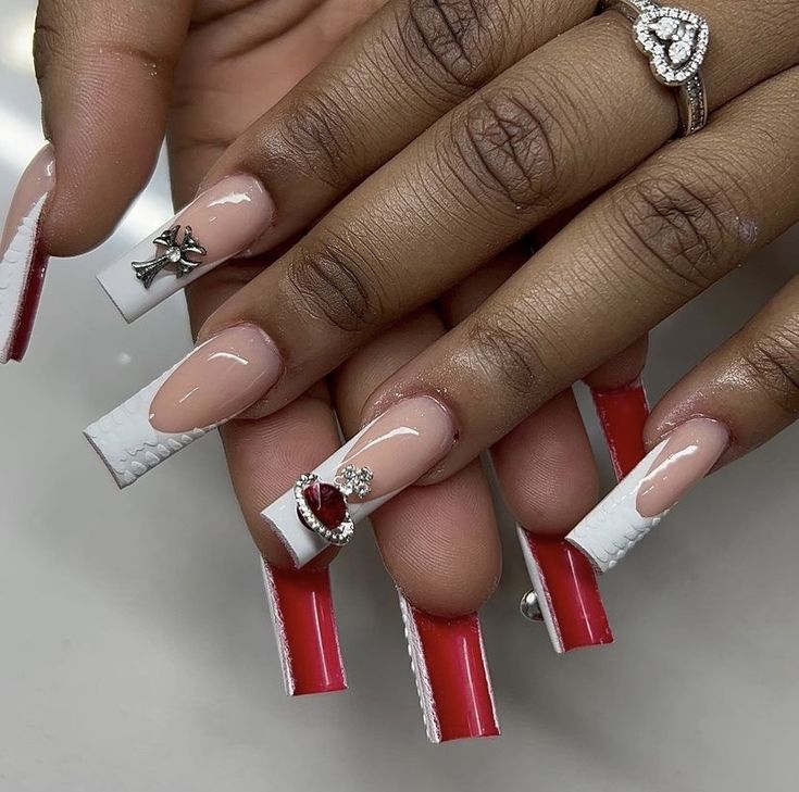 Elegant Red and White Nail Design with Heart Gem and Silver Charm Accents