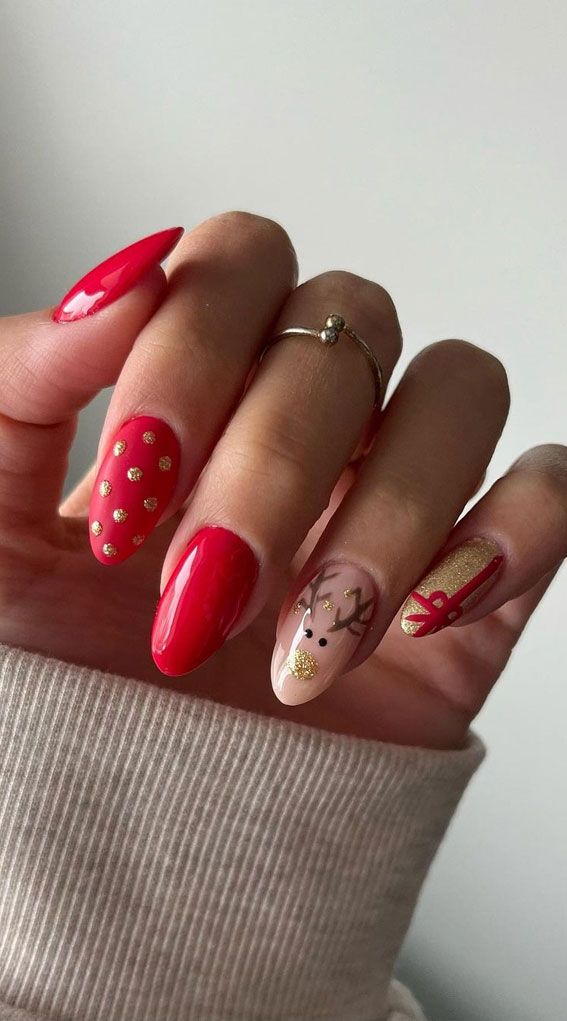 Vibrant Festive Nail Design with Reindeer Motif and Gold Accents.