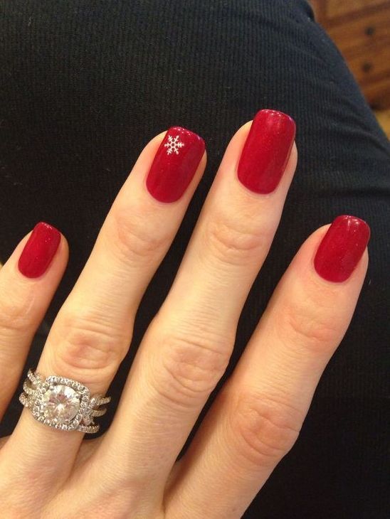 Elegant Winter Holiday Nail Design with Rich Red Polish and Snowflake Accent.