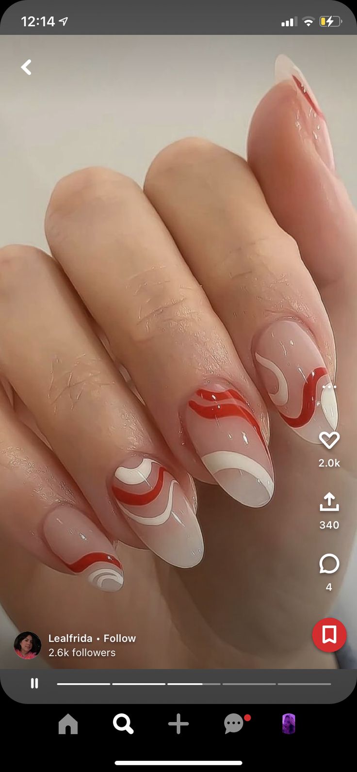 Bold Red and White Swirled Nail Design on Soft Nude Base: A Playful and Elegant Statement.