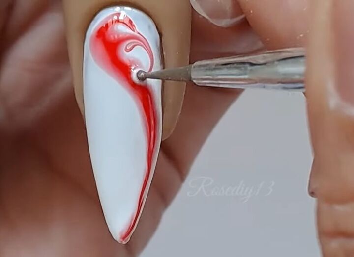 Elegant Nail Design: Striking White Base with Bold Red Abstract Swirls