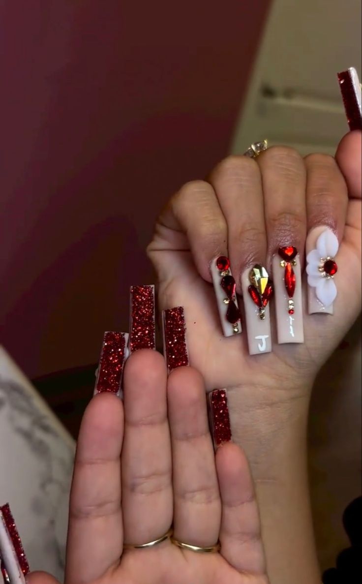 Chic Red and White Nail Design with Rhinestones and Intricate Artistry.