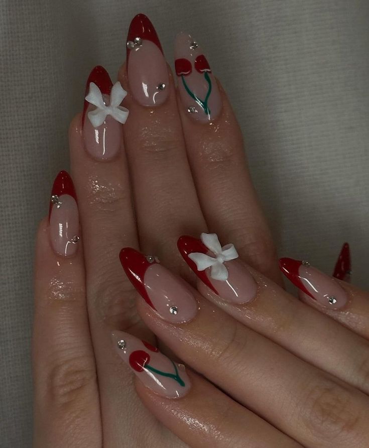 Whimsical Nail Design with Red Tips, Pink Bases, White Bows, and Red Tulip Accents.