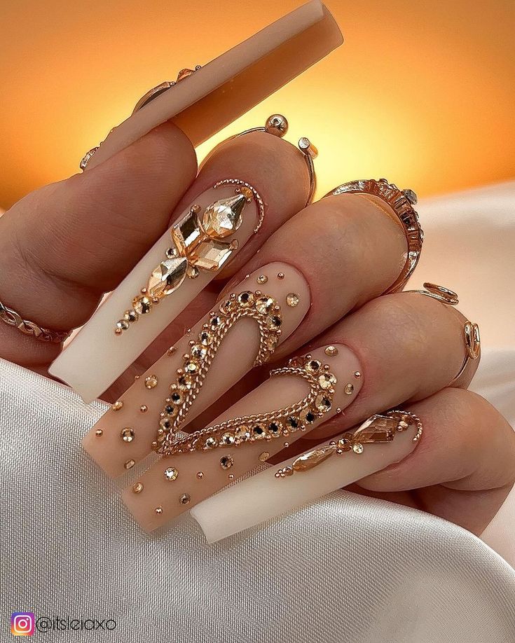 Luxurious Almond-Shaped Nail Design with Intricate Embellishments and Gold Accents.