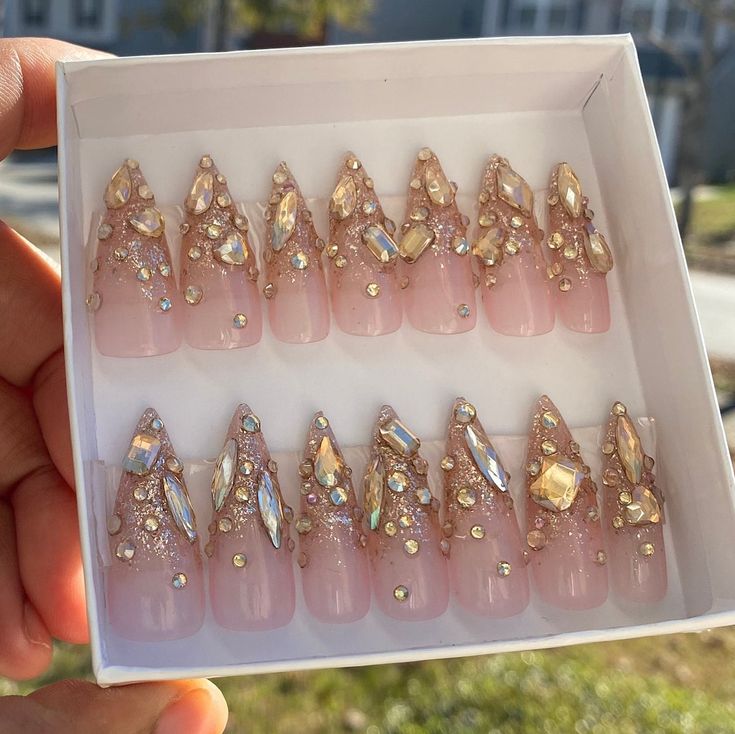 Elegant Almond-Shaped Artificial Nails with Pink Base and Rhinestone Embellishments.