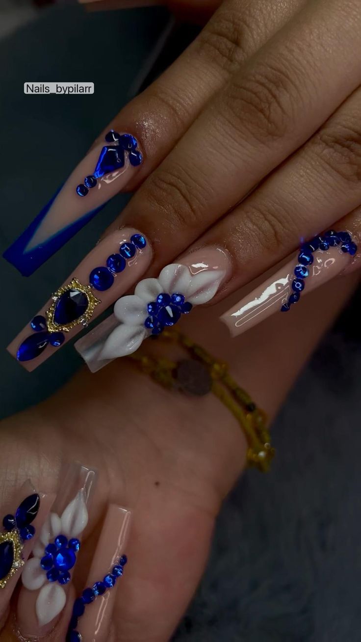 Stunning Nail Design: Clear and Nude Shades with Blue Gemstones and Floral Accents