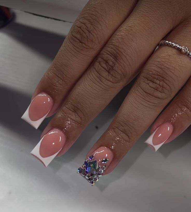 Sophisticated Nude and White Nail Design with Glamorous Rhinestone Accent.