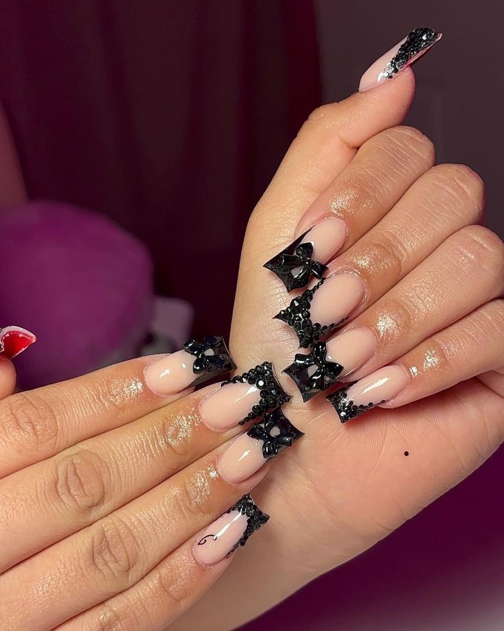 Sophisticated Nail Design with Nude and Black Elements for Special Occasions.