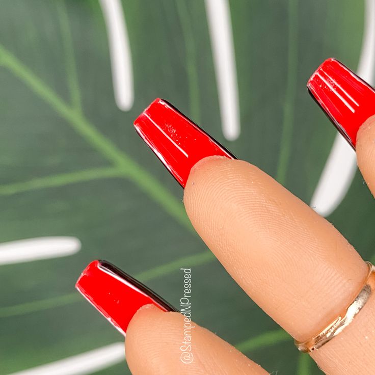 Striking Bold Red Nail Design with Black Outline: A Modern Statement Look.