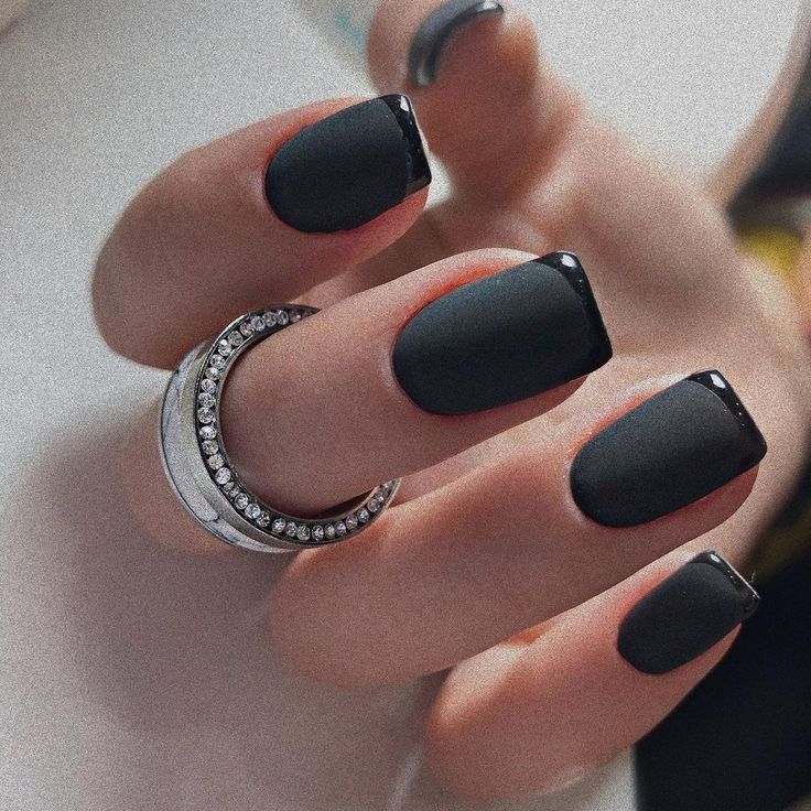 Chic Matte Black Nail Design with Glossy Tips and Elegant Ring Accents.